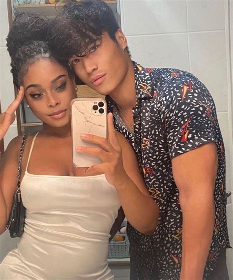 a man and woman taking a selfie in the bathroom