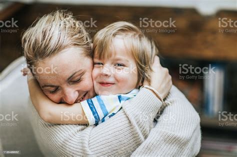 Affectionate Mother And Son Embracing At Home Stock Photo Download
