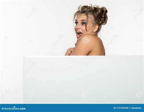 Expressive Girl Standing Behind And Leaning On A White Blank Billboard