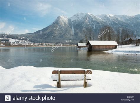 A Snow Covered Bench Facing Hallstatter See And The Surrounding