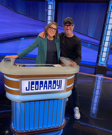 Download Two People Standing In Front Of A Jeopardy Board