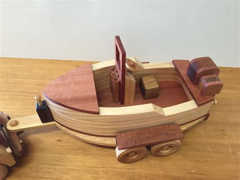 A Wooden Toy Boat Sitting On Top Of A Table Next To A Pair Of Scissors