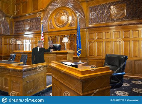 A Witness Stand With A Black Seat In The Court Room Infront Of Tribunal