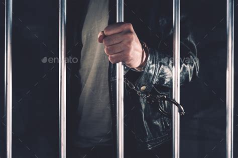 Handcuffed Man Behind Prison Bars Stock Photo By Stevanovicigor Photodune