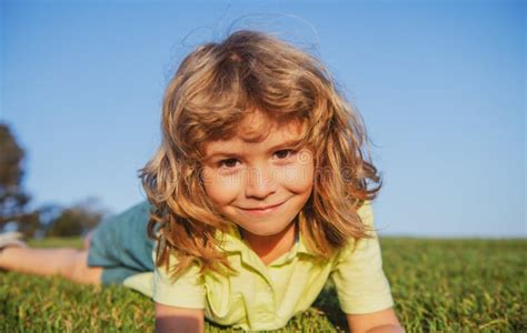 Kid Playing In The Meadow Happy Healthy Caucasian Child Boy With Lying