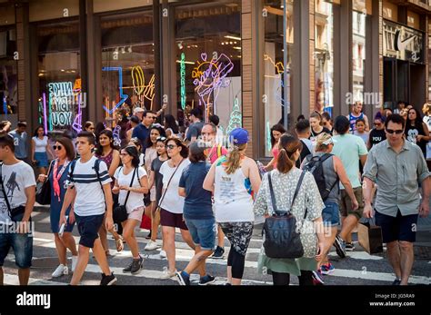 Hordes Of Shoppers Cross Spring Street At Broadway In Soho In New York