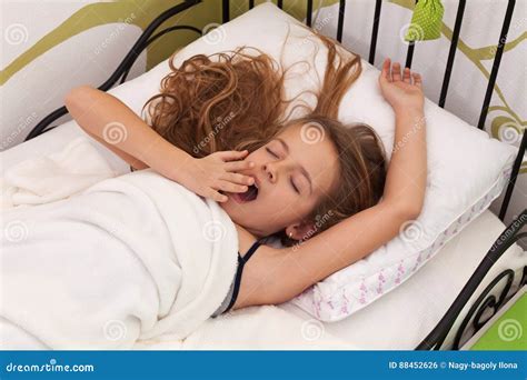 Young Girl Waking Up In Her Bed Stock Photo Image Of Girl Arms 88452626