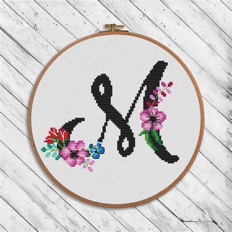 So we've combined over 50 free cross stitch fonts and alphabets for you to download and use for free. Letter M of Black floral cross stitch monogram botanical ...
