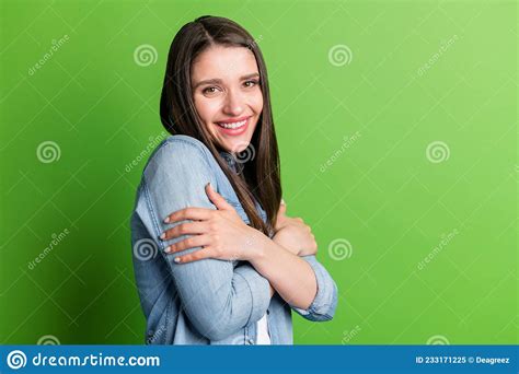 profile side view portrait of attractive cheerful girl hugging herself isolated over bright
