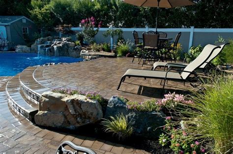 Different Level Patios Flower Beds And Raised Waterfall Make Backyard
