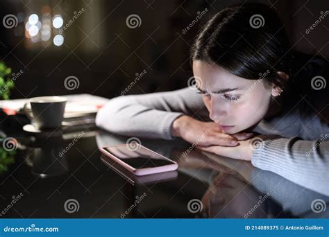 Sad Woman Waiting For A Phone Call In The Night At Home Stock Image