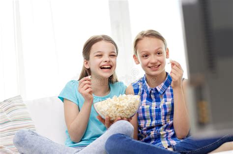 Want to watch 'tiger king' with the whole gang? Happy Girls With Popcorn Watching Tv At Home Stock Photo ...