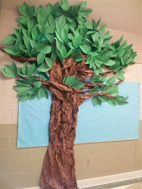 A Tree Made Out Of Paper Sitting On Top Of A Wall