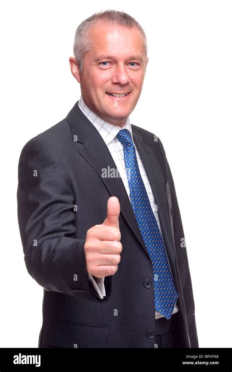 Mature Businessman In Suit And Tie Giving A Thumbs Up Gesture Towards