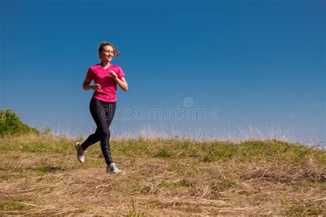 Young Woman Jogging On Sunny Day At Summer Mountain Stock Photo Image
