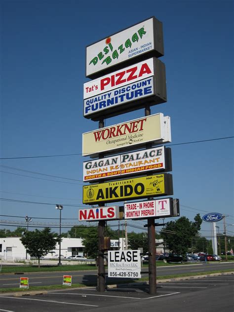 Signs In Front Of A Strip Mall That Is Located In Front Of Flickr