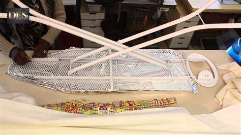 The pad (with the rod running through it) is fixed on one side to the ironing board and a spring pushes it vertically from the bottom to create friction. Re vamping Ironing board cover part 1 - YouTube