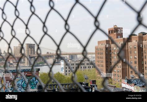 Brooklyn Bridge And East River New York City Through Wire Fence Stock