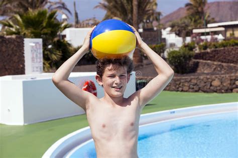 Cute Teen Boy Carrying A Plastic Ball On His Head Stock Photo Image