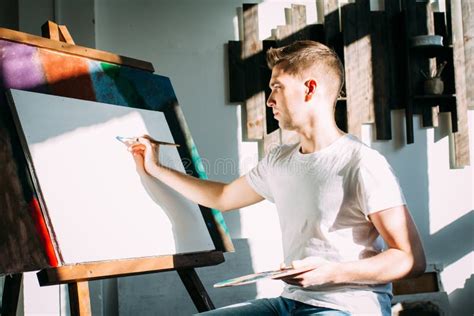 Young Man Artist Paints A Picture Stock Image Image Of Canvas