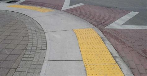 The Actual Purpose Of Those Colorful Sidewalk Bumps Go