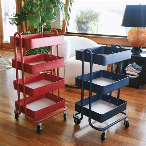 Two Red And One Blue Trolleys Sitting On Top Of A Hard Wood Floor Next