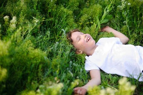 Child Is Lying On The Grass Stock Image Image Of Children Flower