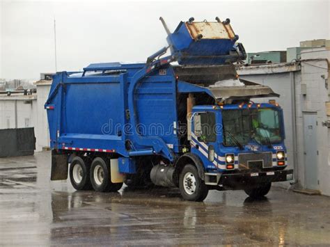 Trash Truck Blue Garbage Truck Collecting Trash In The Rain