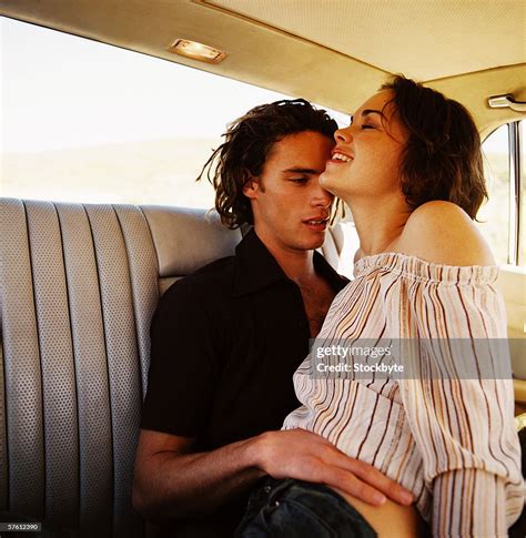 Closeup Of A Young Couple Making Out In The Back Seat Of A Car High Res