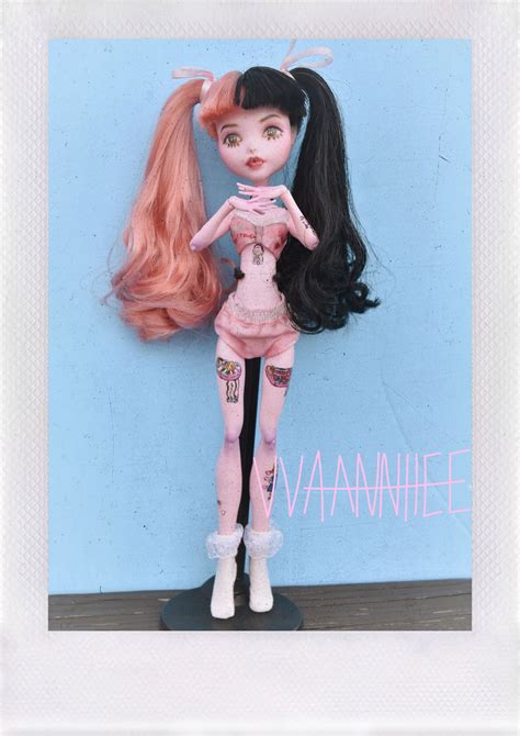 An Image Of A Doll With Pink Hair And Tattoos On Her Body Standing In