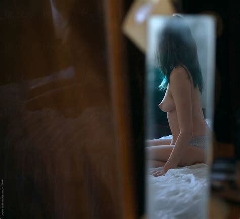 Girl Posing Without Clothes Topless In Mirror Reflection By Stocksy