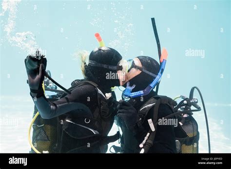 Couple Kissing Underwater While Scuba Diving Stock Photo Alamy