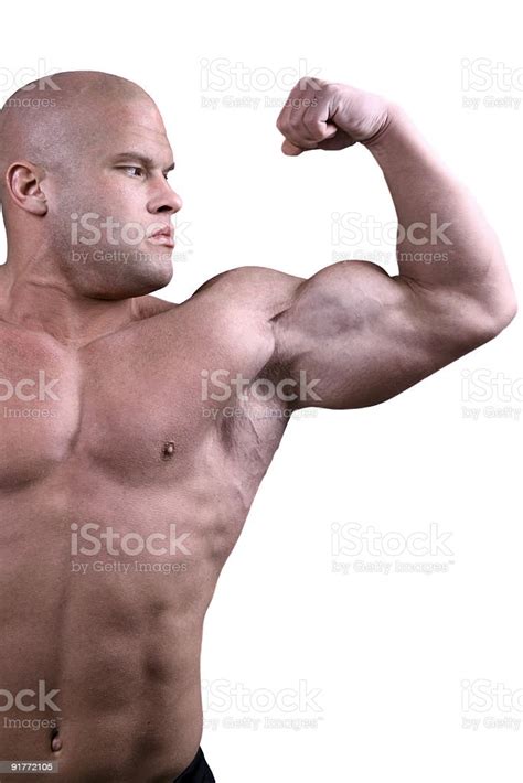 Man Flexing Biceps To Show Off His Strength Stock Photo Download