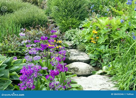 Cottage Garden Stone Steps Between Summer Flowers And Plants Stock