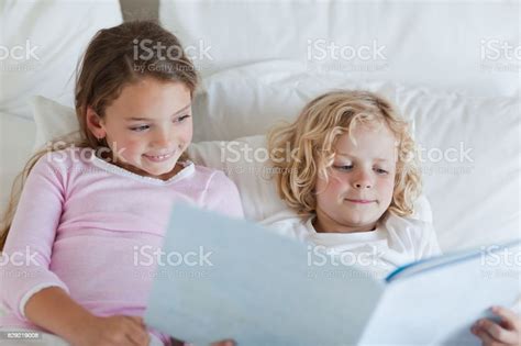 Brother And Sister Reading Bed Time Story Together Stock Image Everypixel