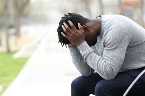 Sad Depressed Black Man On A Bench In A Park Stock Photo Image Of