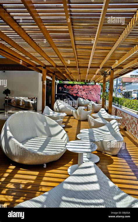 Sun lounge. modern white painted wicker furnishing utiilised in a