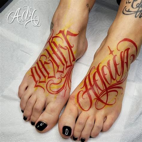 Two Feet With Red And Yellow Ink On Them One Has The Word Faith