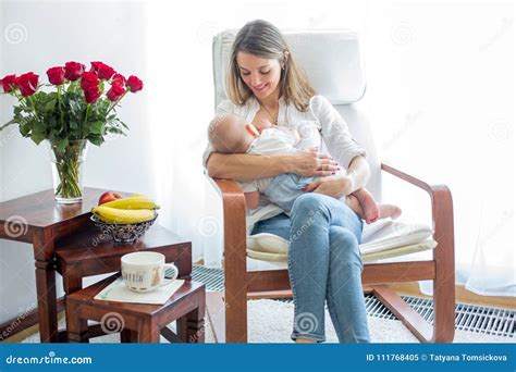 Mother Playing With Her Toddler Boy Breastfeeding Him Stock Image