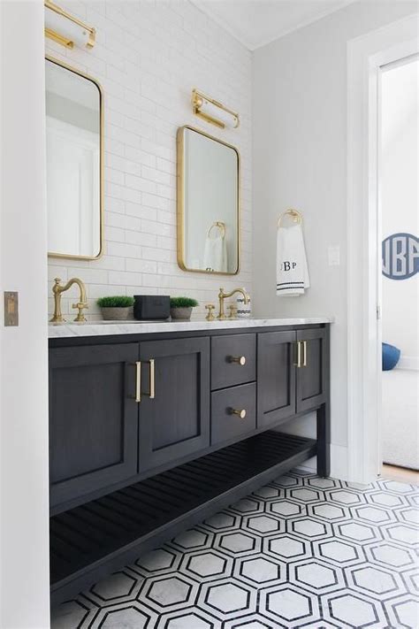 Black And Gray Marble Floor Tiles Lead To A Black Wooden Dual Bath