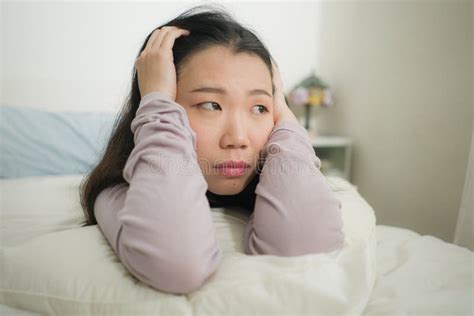 Young Asian Woman Depressed Young Beautiful And Sad Japanese Girl On Bed With Pillow Feeling