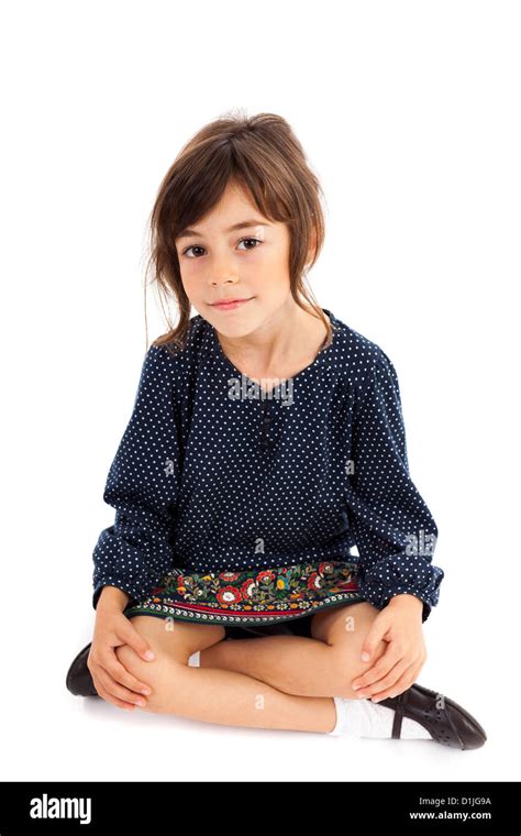 Full Length Portrait Of A Little Girl Sitting With Crossed Legs