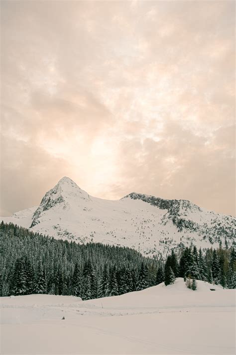 Photo Of Snow Covered Mountains Under Cloudy Sky · Free Stock Photo