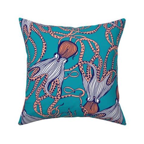 A Blue Pillow With An Octopus And Squid Design On The Front Sitting On