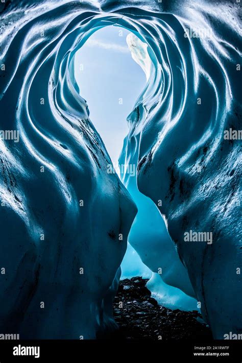 Tall Archway Entrance To Deep Blue Ice Cave In The Matanuska Glacier In
