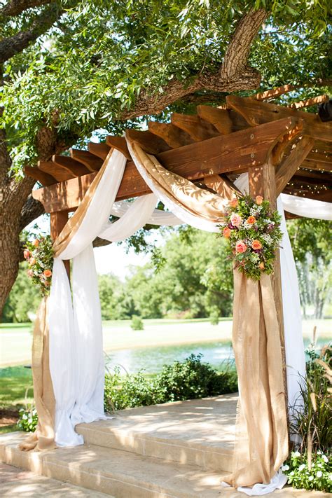 Burlap Draping With Country Pink And Green Flowers Over A Wooden