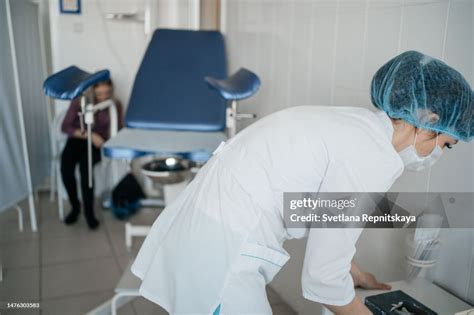 woman doctor gynecologist preparing for a routine examination of the patient high res stock
