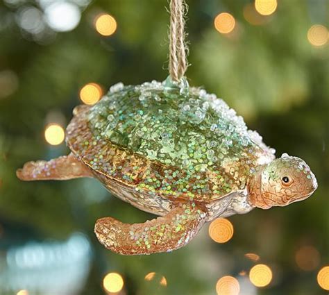 A Glass Turtle Ornament Hanging From A Christmas Tree