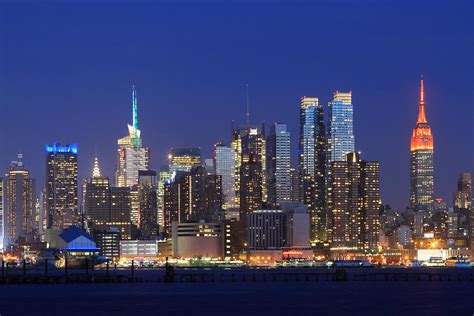 Taken with a canon 5d and 85mm f/1.8 lens at f/1.8, iso 800 and 1/40s exposures. Manhattan Skyline At Night Photograph by John Lan