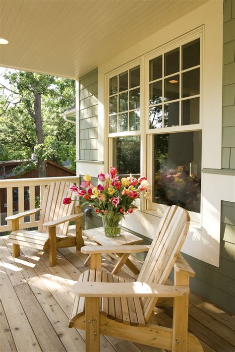 A Simple Pine Front Porch With A Pair Of Wooden Lounge Chairs The